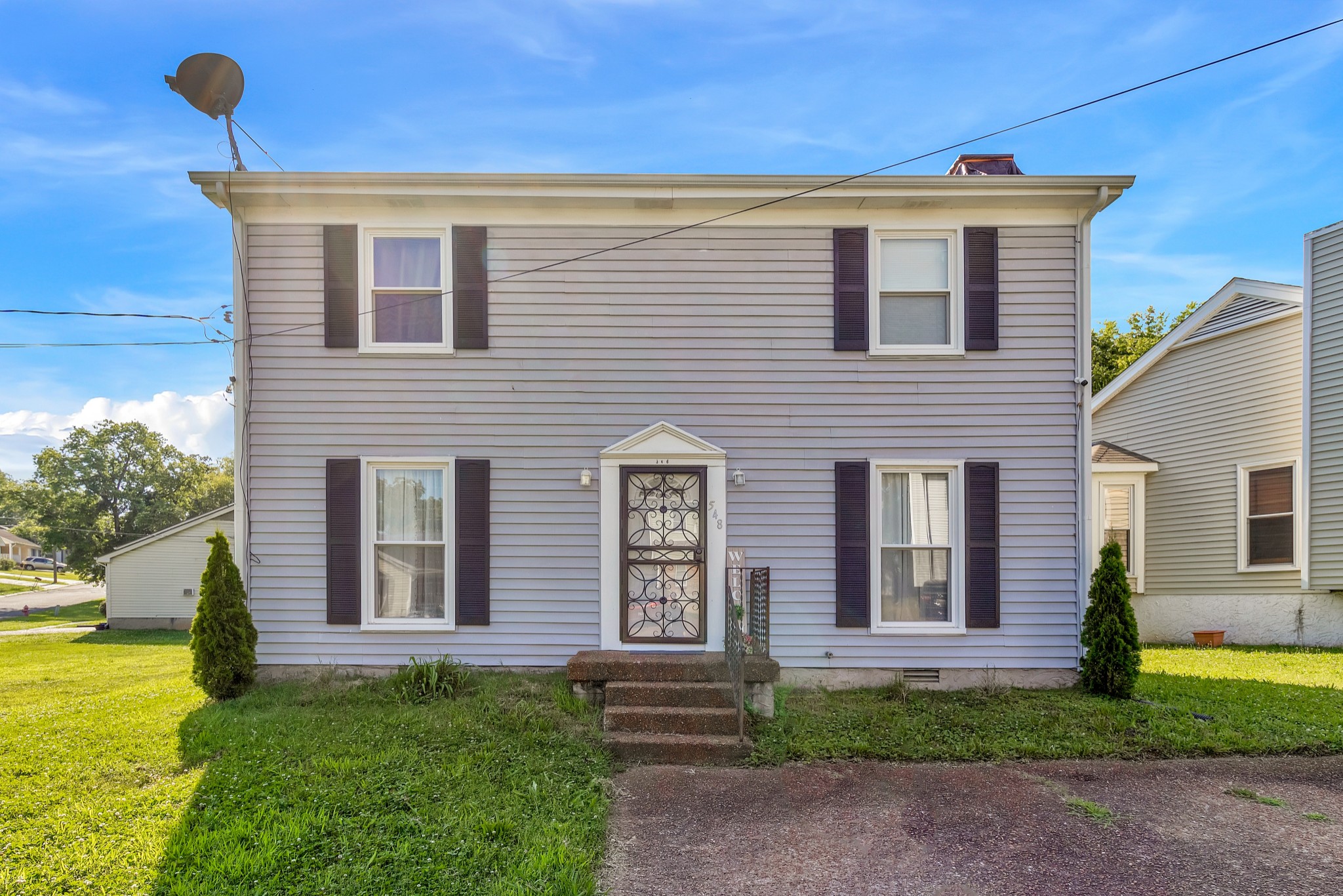 a front view of a house with garden