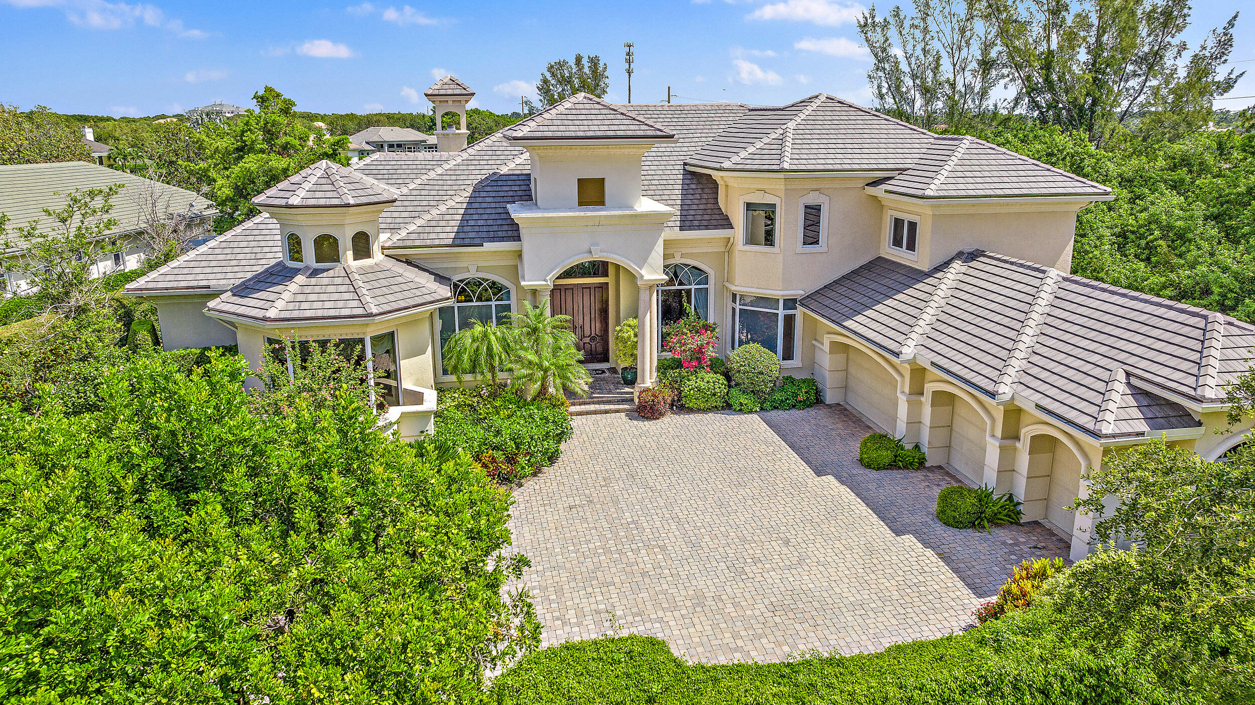 a front view of a house with a yard and fountain