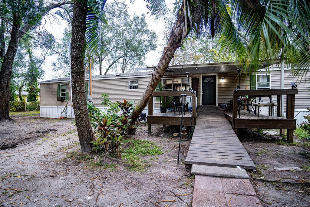 a view of a house with backyard and sitting area