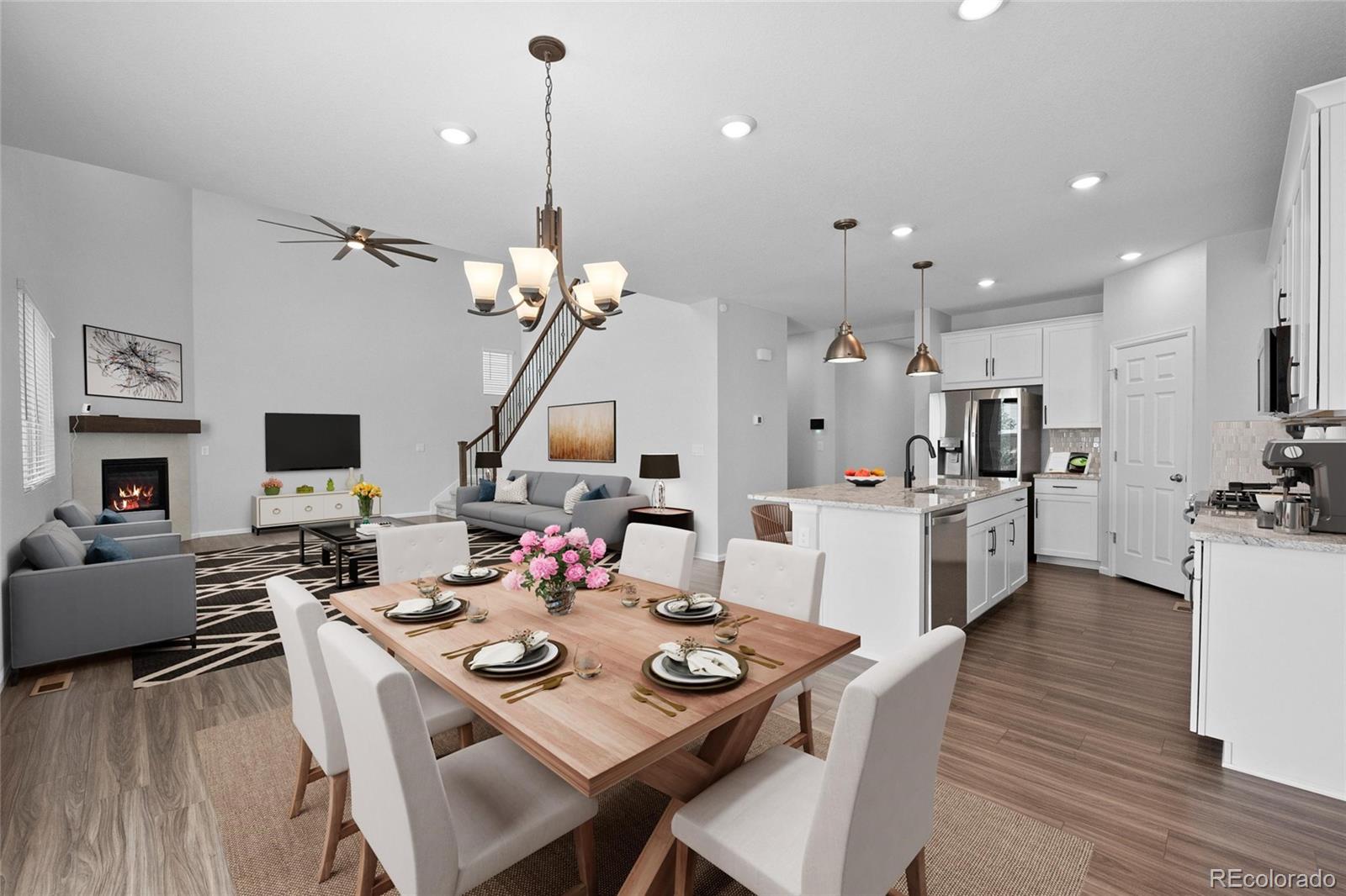 a view of a dining room and livingroom with furniture wooden floor a chandelier