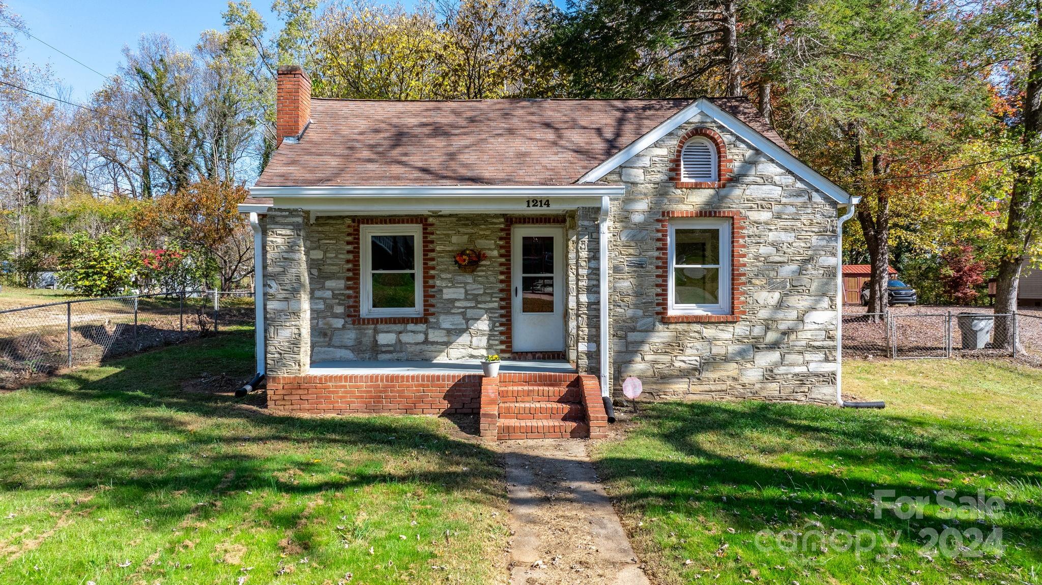 a front view of house with a garden