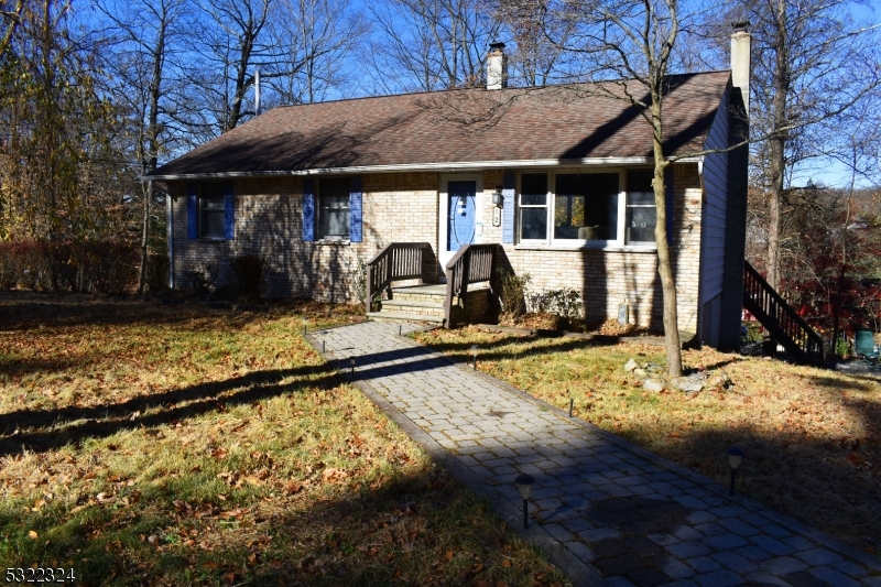 a view of a house with floor to ceiling windows and a table