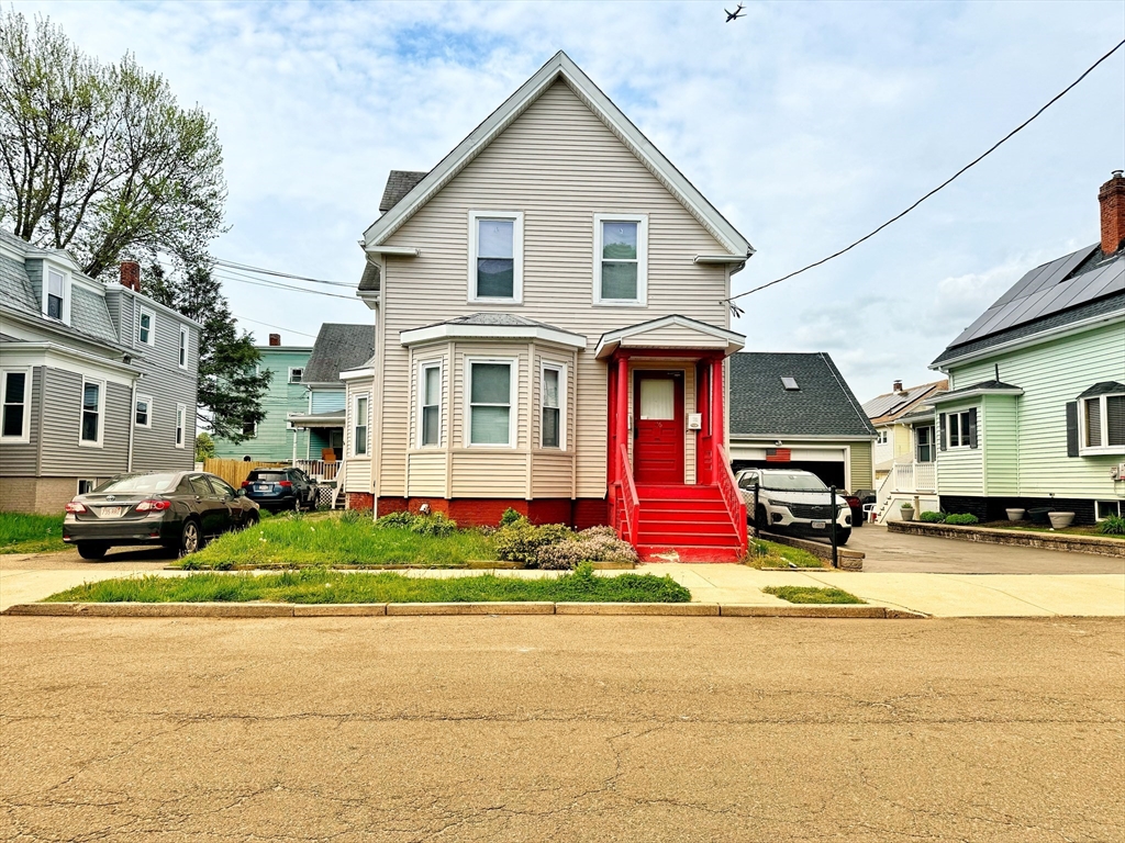 a front view of multiple houses with yard