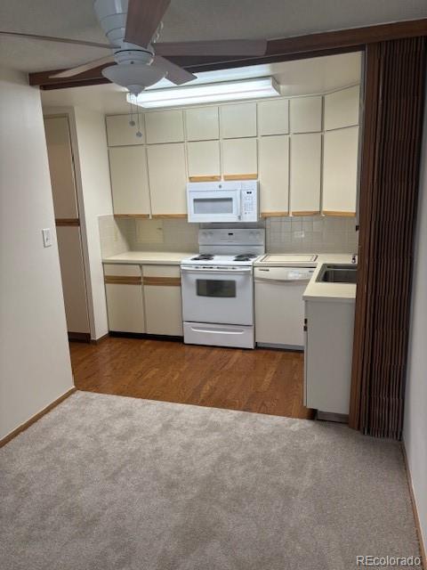 a kitchen with a stove and white cabinets