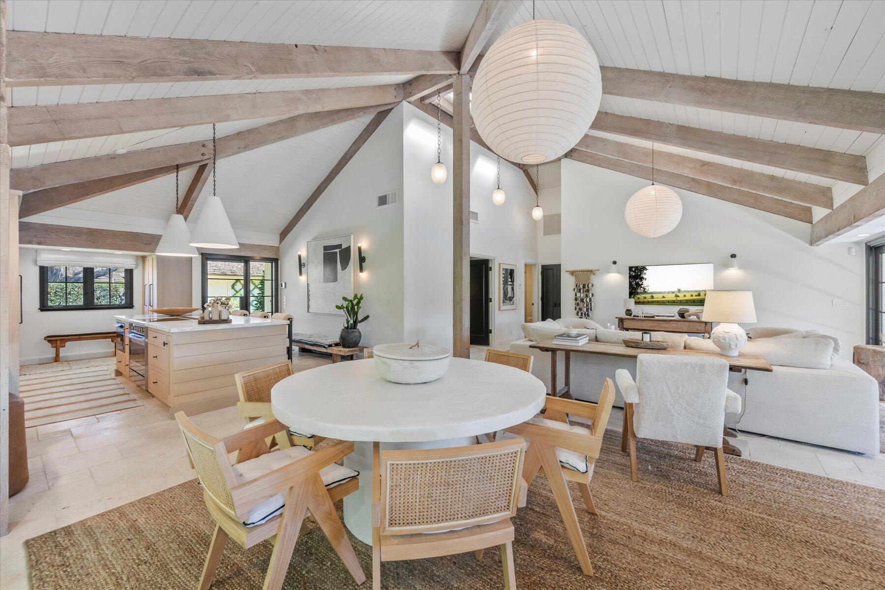 a dining room with wooden floor a glass table and chairs