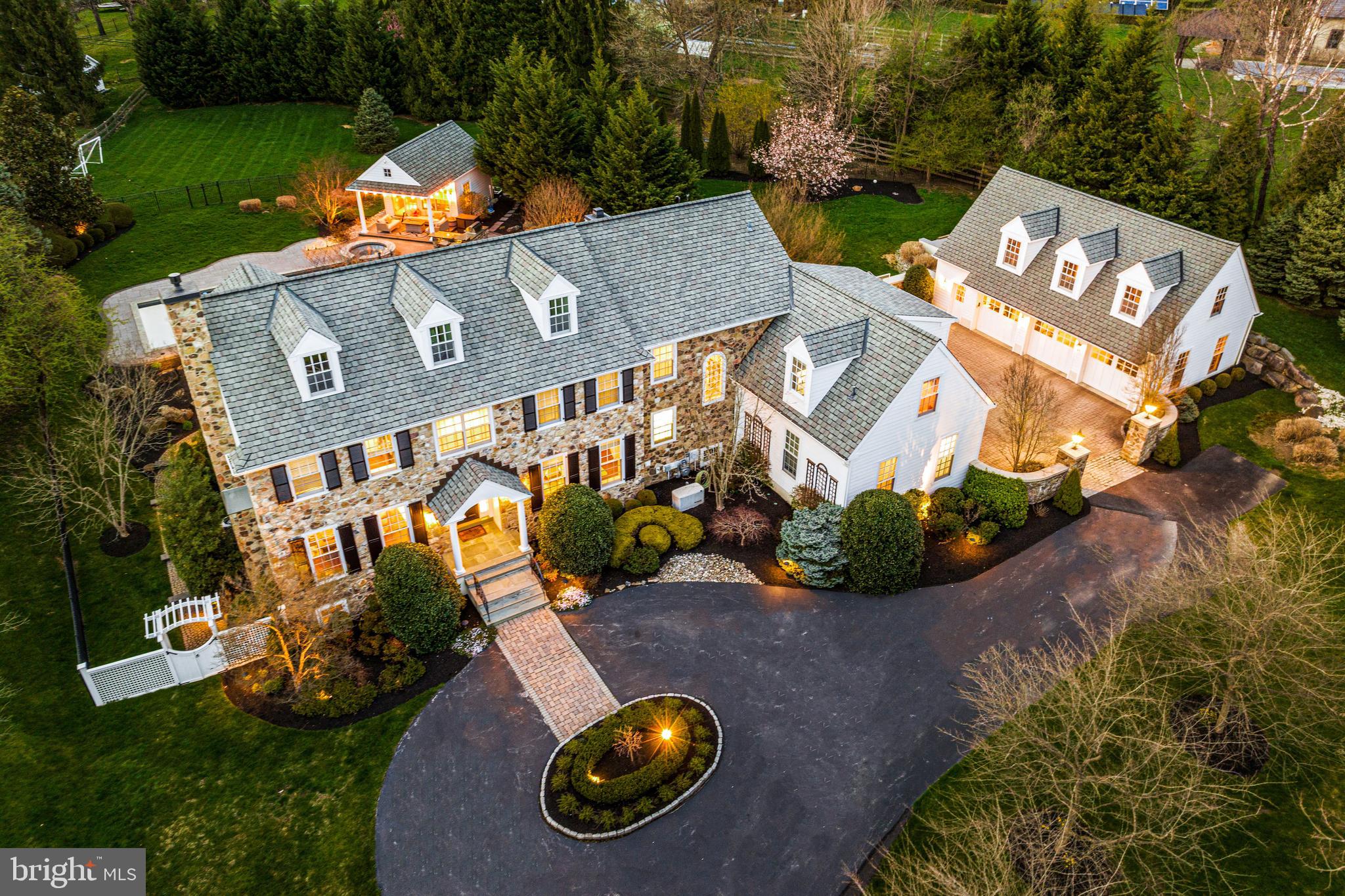 an aerial view of a house with a garden and swimming pool