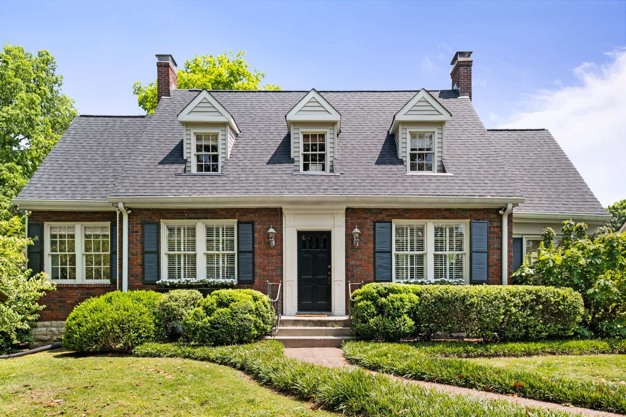 a front view of a house with garden