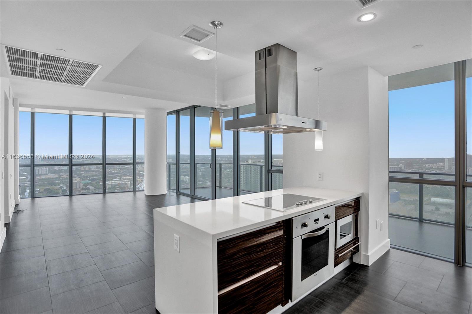 a kitchen with a stove and a view of living room