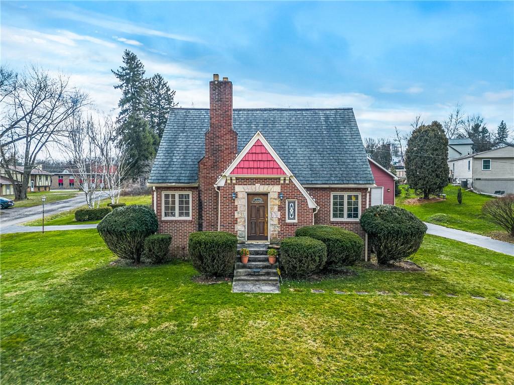 a aerial view of a house next to a yard