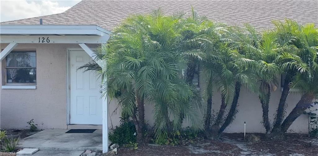 a view of a house with a tree