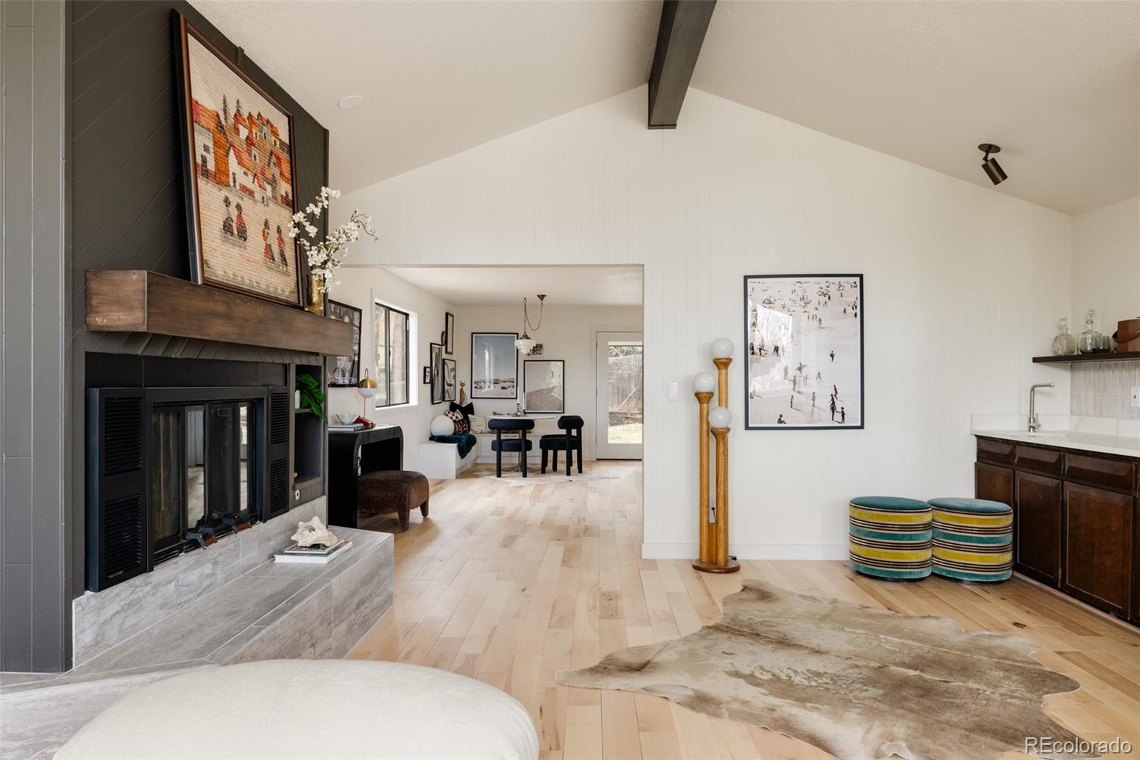 a living room with furniture stove and a fireplace