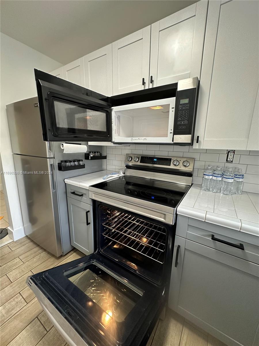 a kitchen with a stove and a microwave