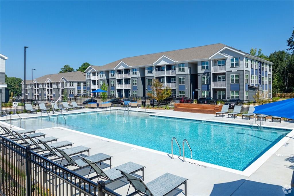 a view of a swimming pool with outdoor seating