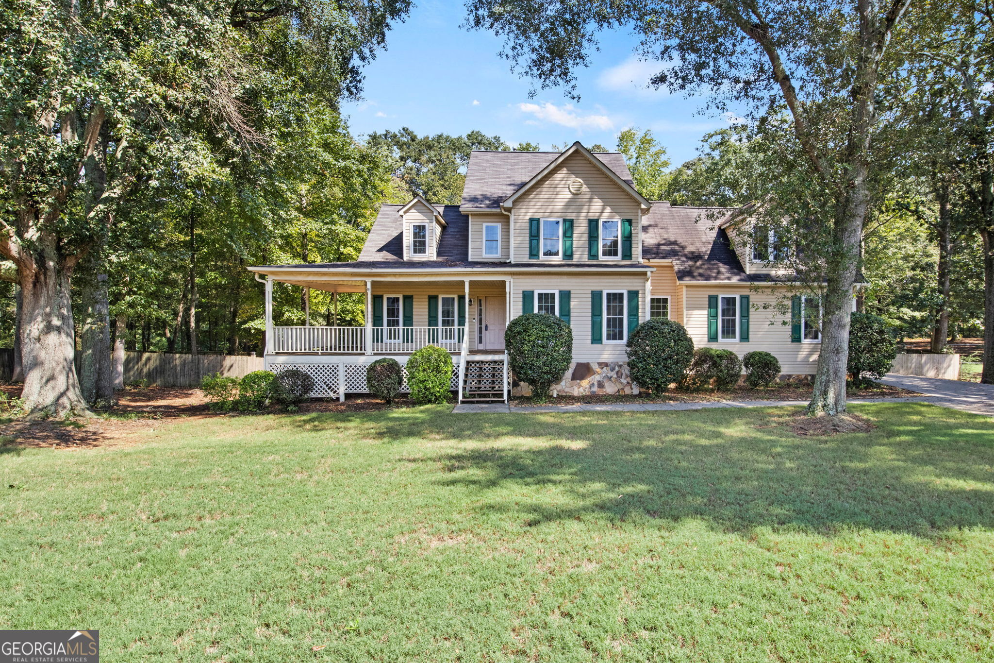 a front view of a house with a garden