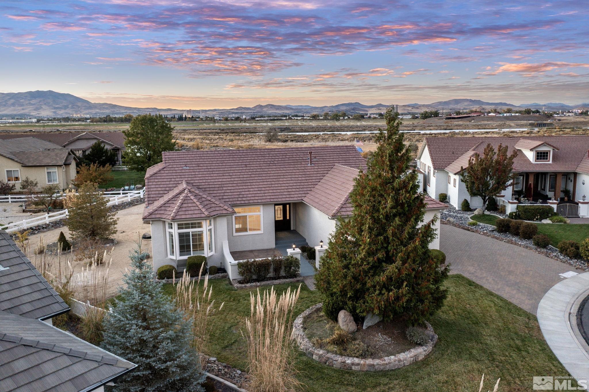 a aerial view of a house with a yard and lake view