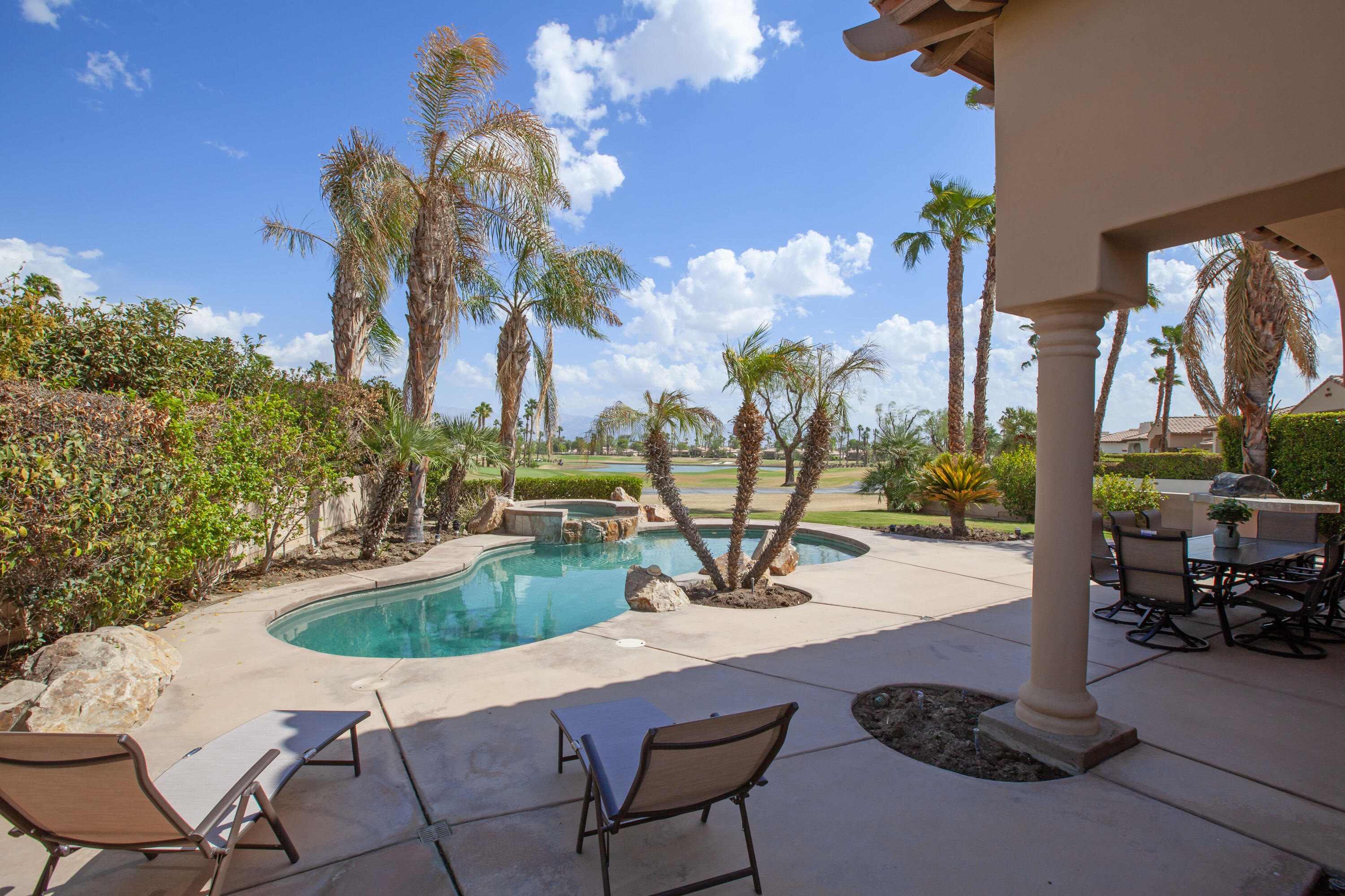 a view of a backyard with swimming pool