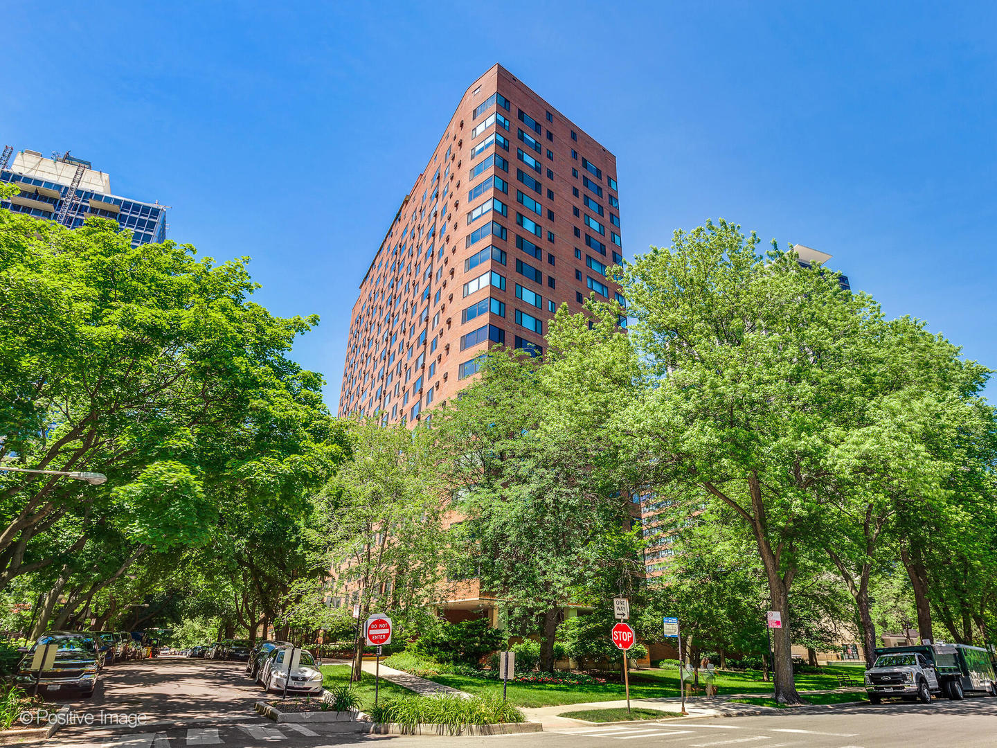 a view of a tall building with a yard