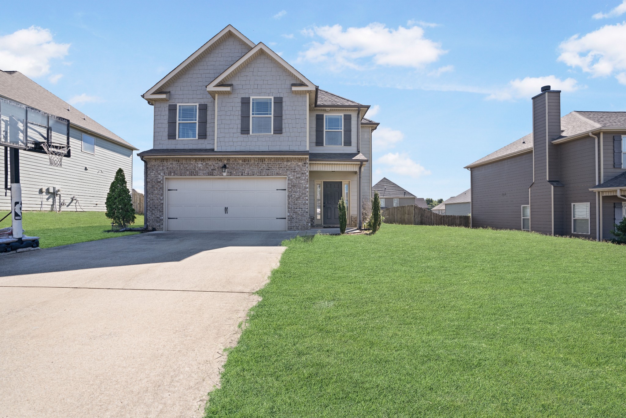 a front view of a house with a yard and garage