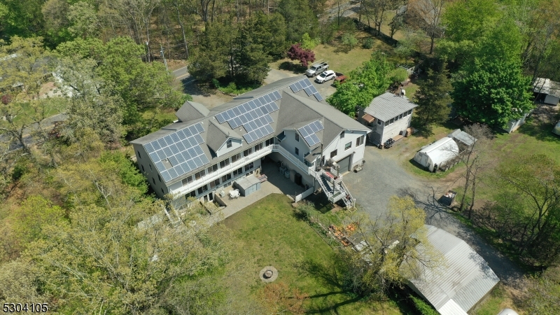 an aerial view of a house with yard and outdoor seating