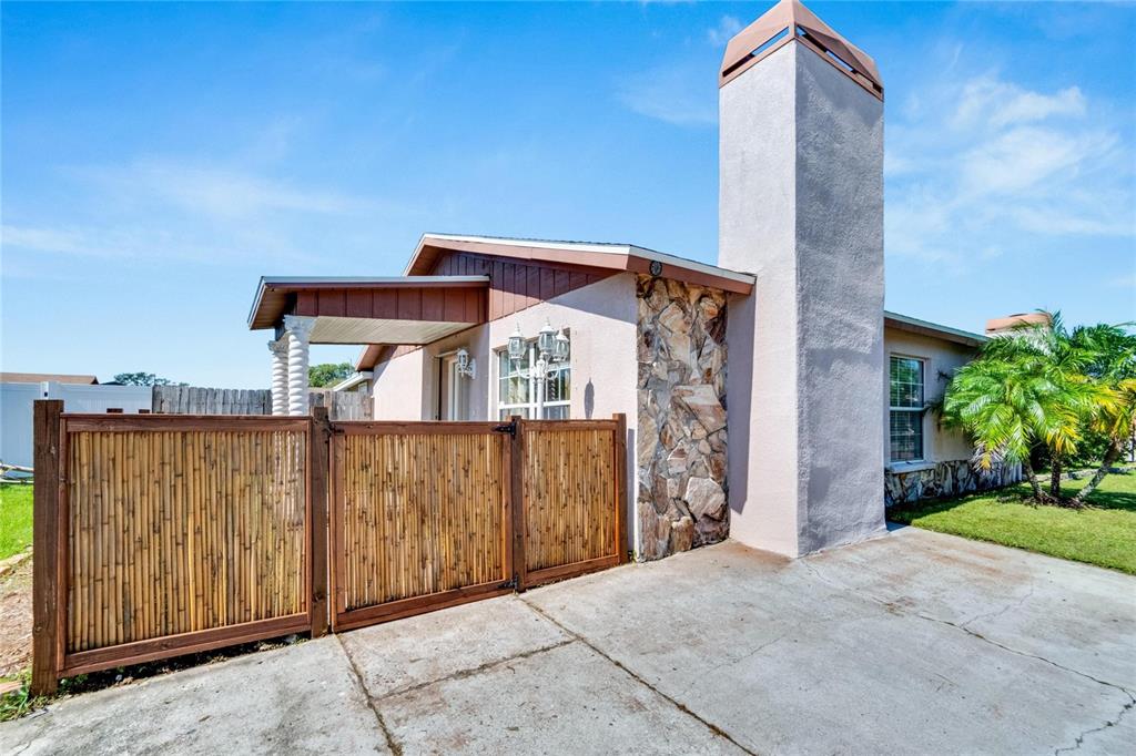 a view of a house with a wooden fence