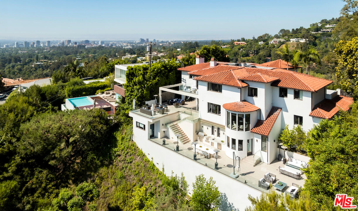 an aerial view of multiple houses with yard