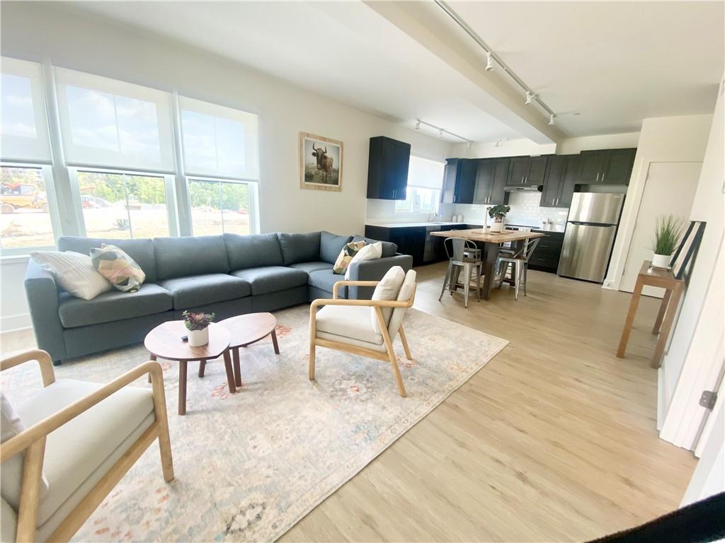 Living room featuring light hardwood / wood-style floors and track lighting