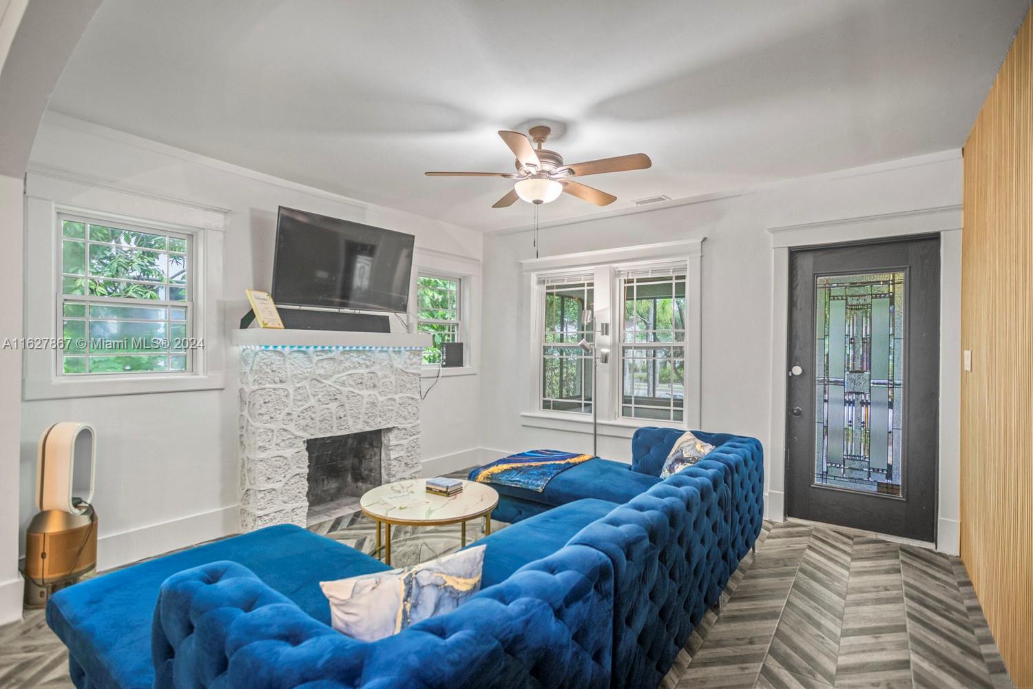 a living room with furniture and a fireplace