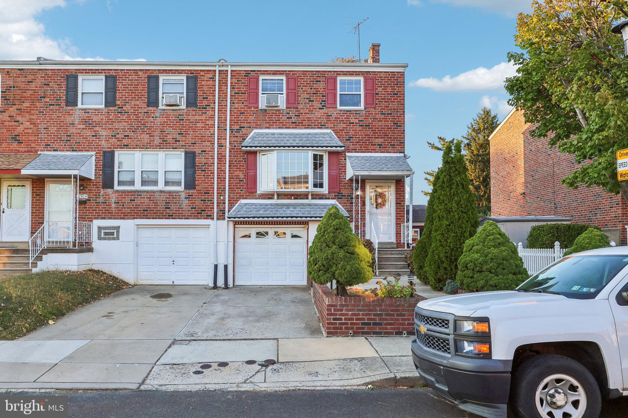 a front view of a residential apartment building with a yard