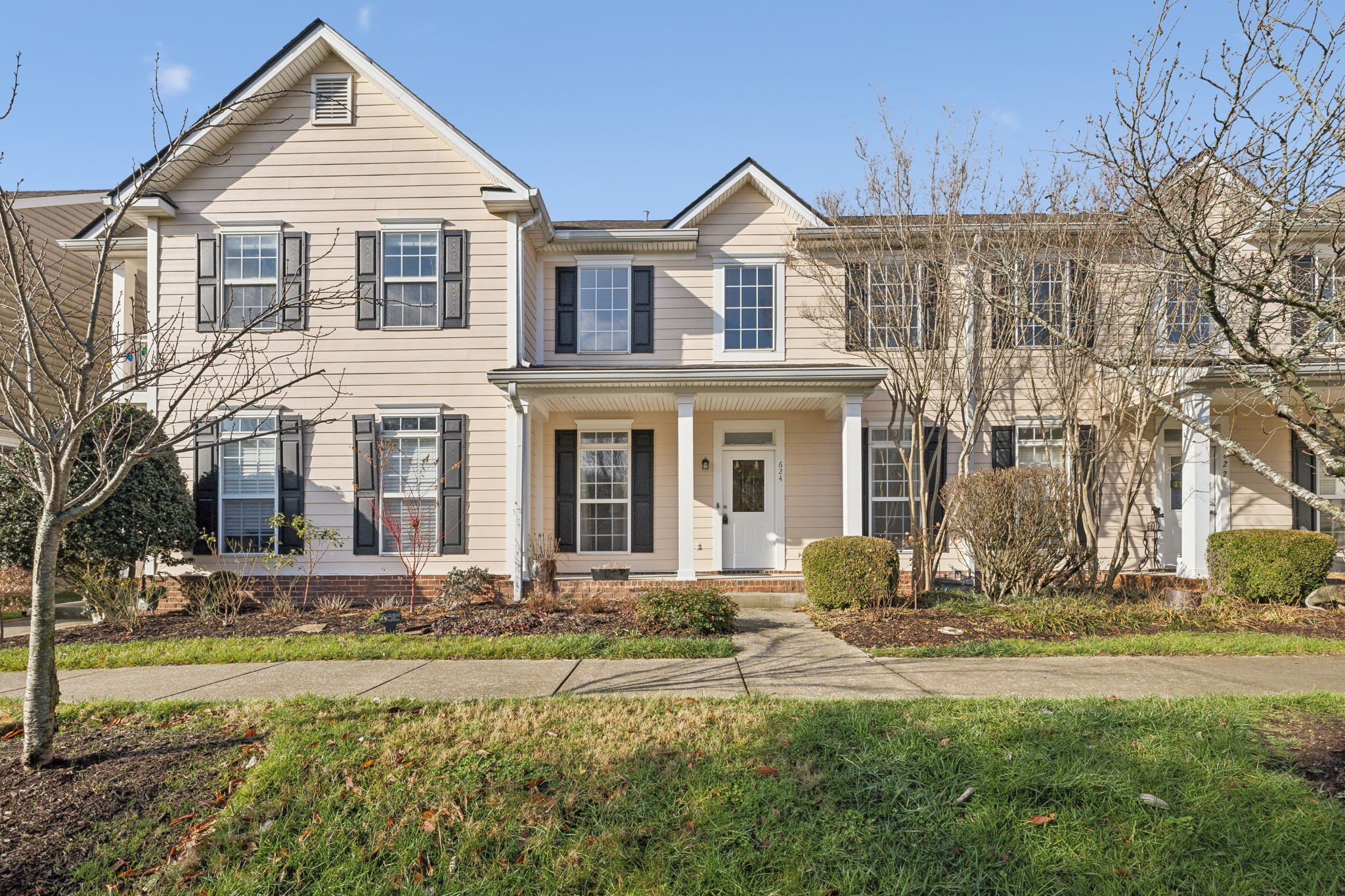 a front view of a house with a yard