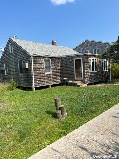 a view of a house with a yard porch and sitting area