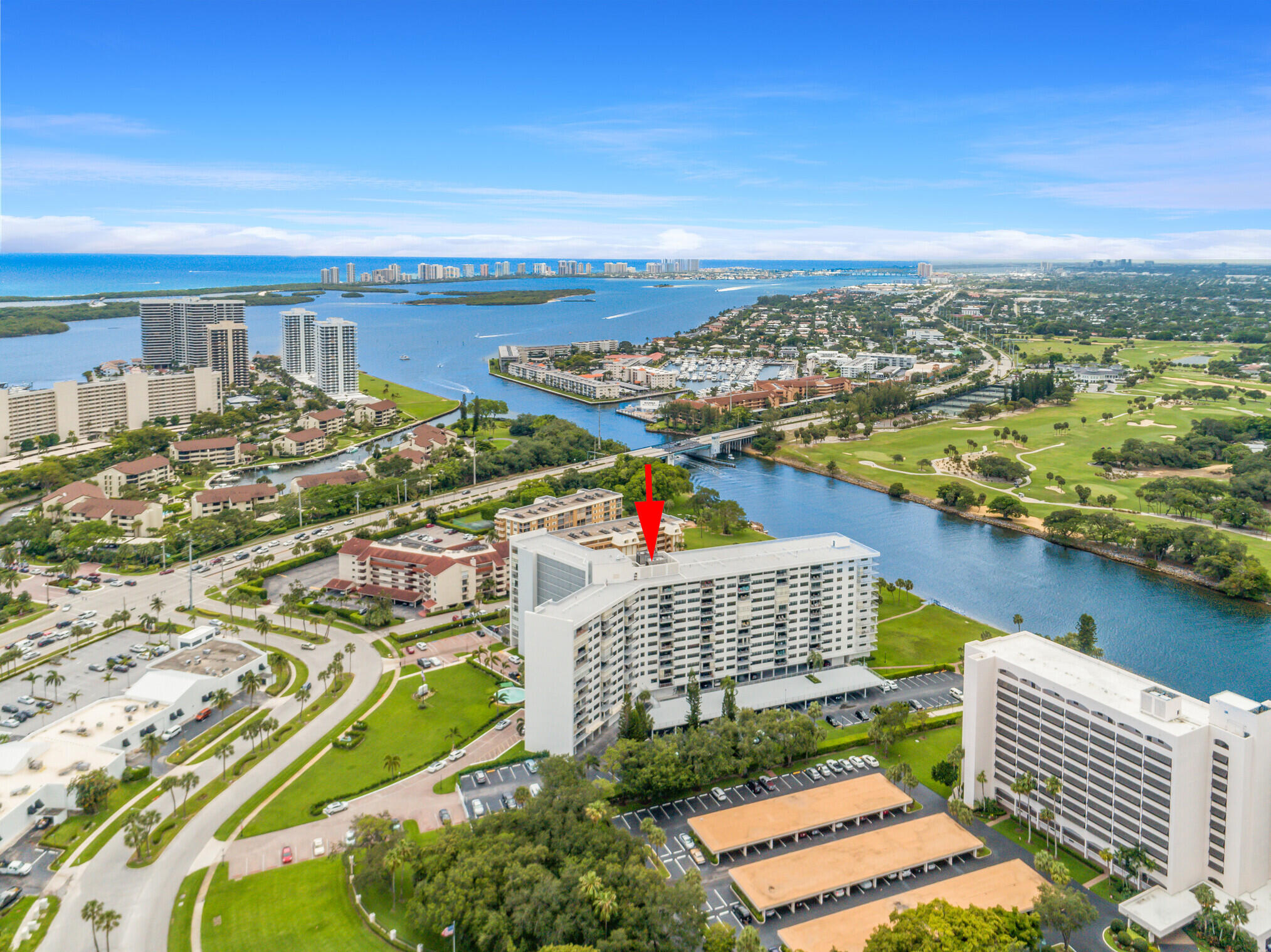 an aerial view of city and lake with trees all around