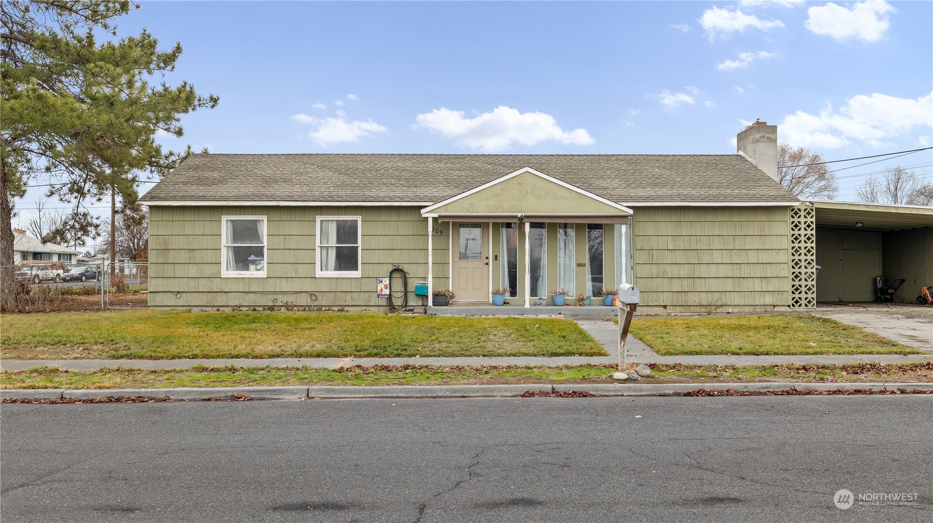 a front view of a house with a yard and outdoor seating