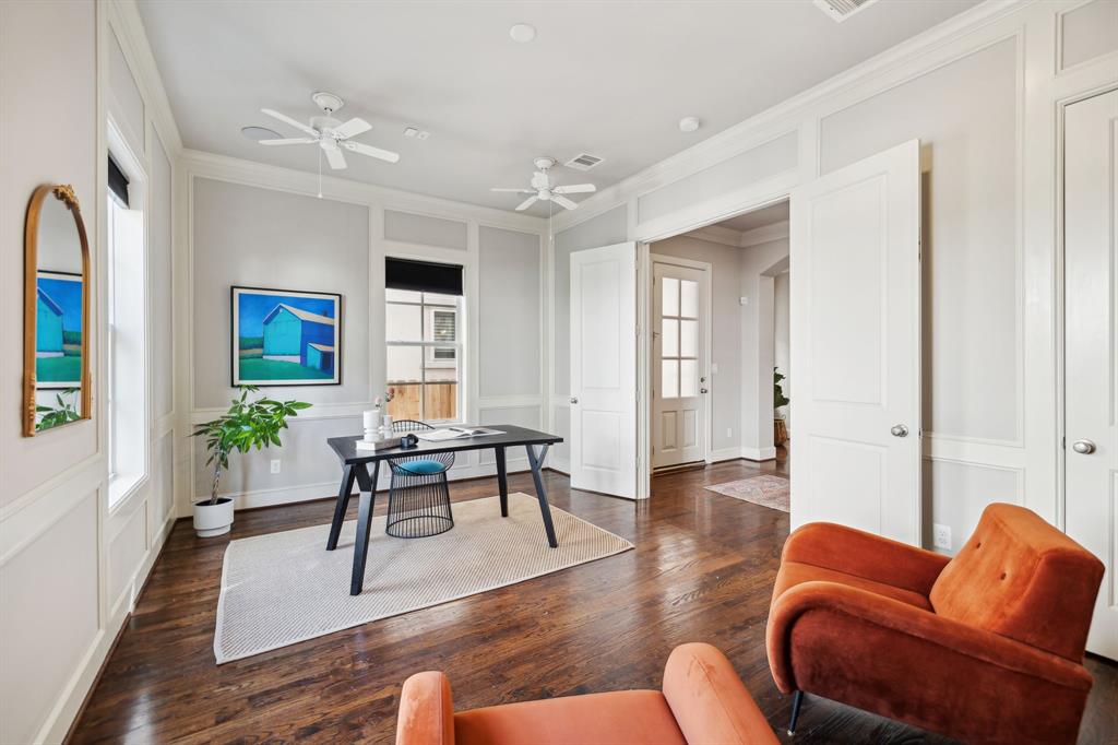 This spacious room w/closet, highlighted by beautifully crafted walls and rich hardwood floors, is perfect for an office or flex space. The large windows not only offer a peaceful view but also fill the room with light, enhancing its warm and inviting ambiance