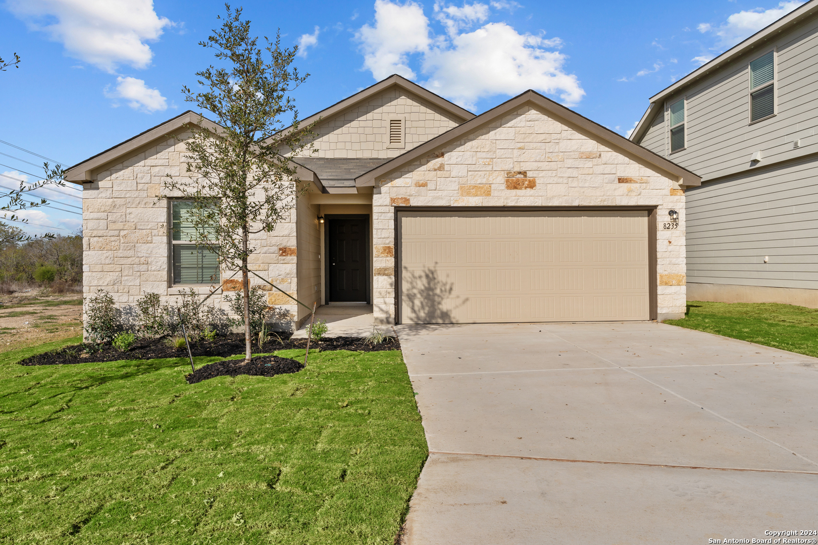 a front view of a house with a yard and garage