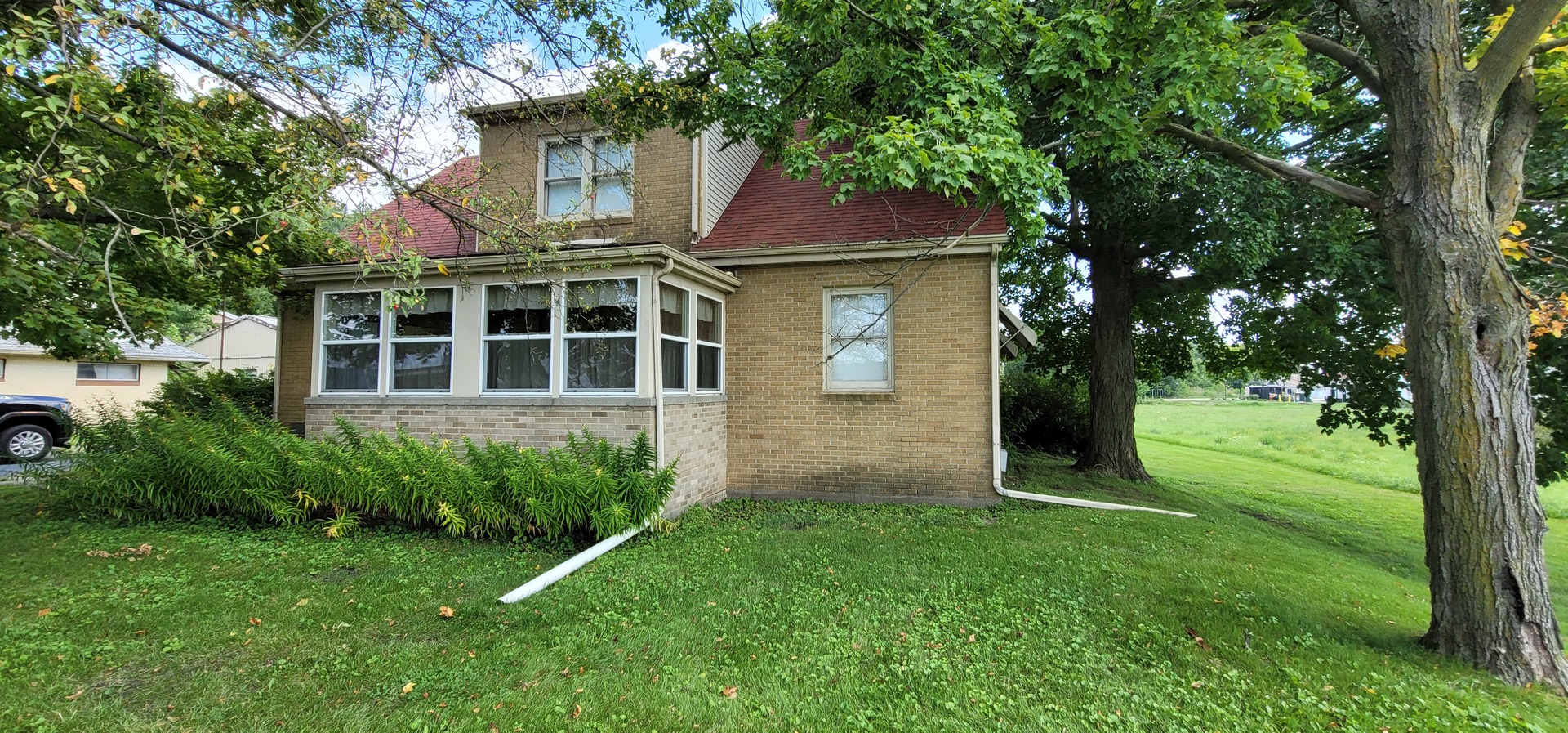 a view of an house with backyard space and garden