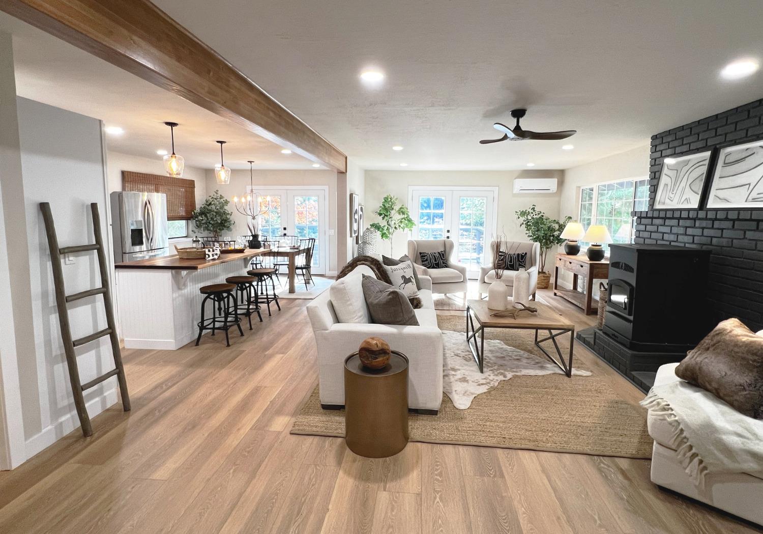 a living room with fireplace furniture and a wooden floor