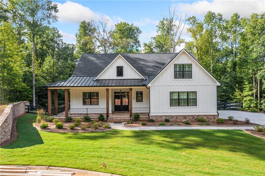 a front view of house with yard and outdoor seating