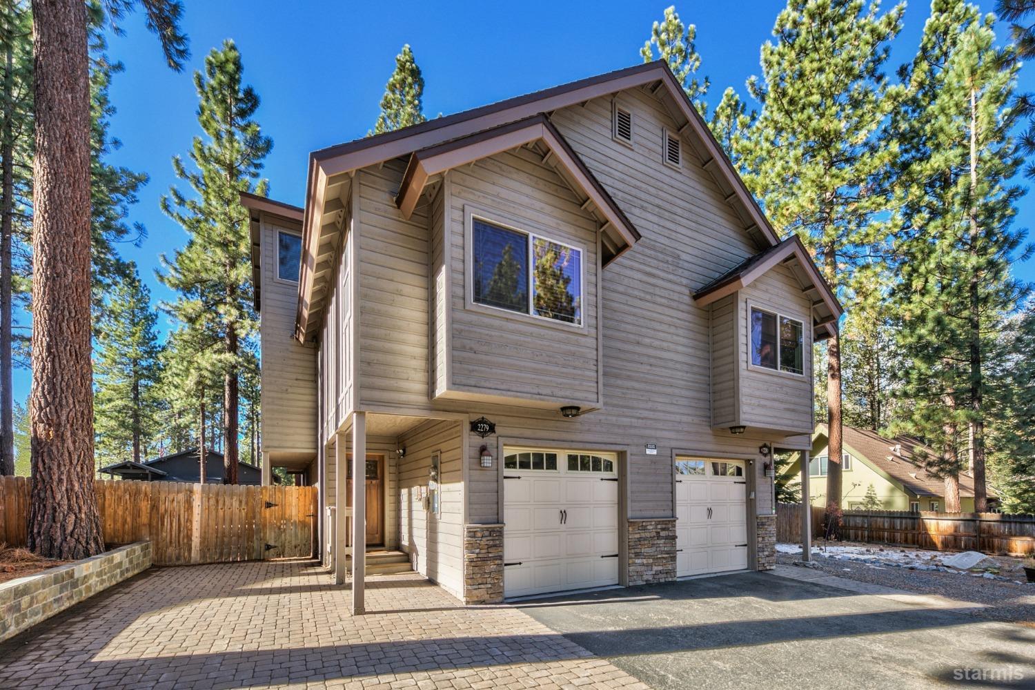 a front view of a house with a tree