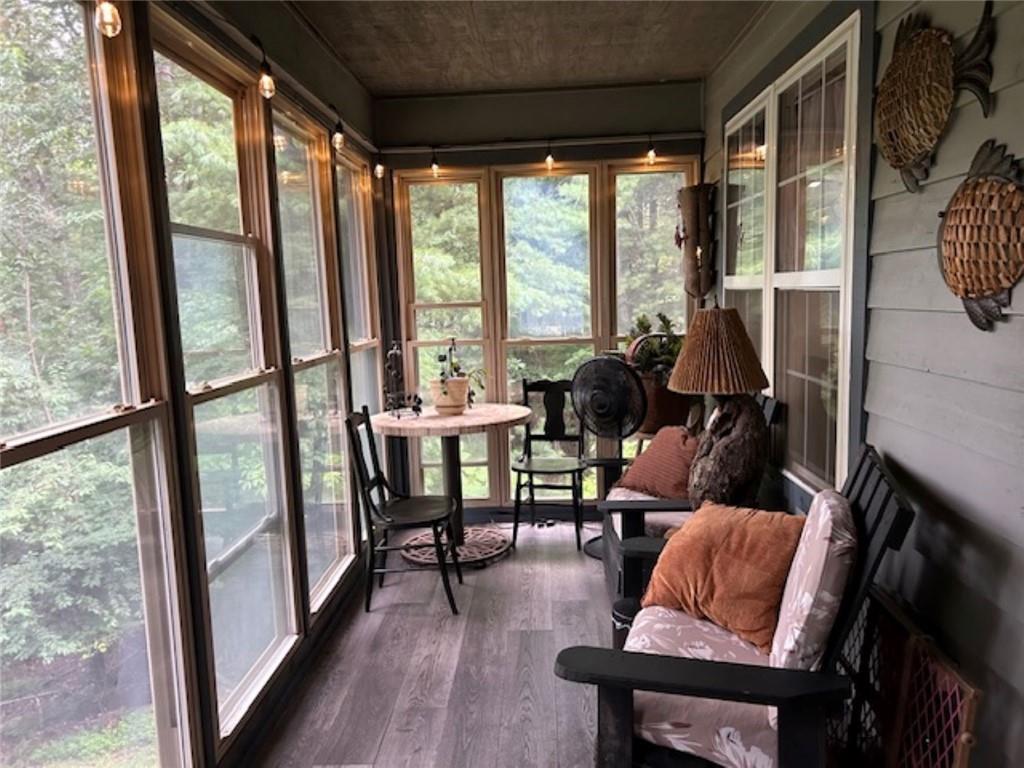 a living room with furniture and a floor to ceiling window