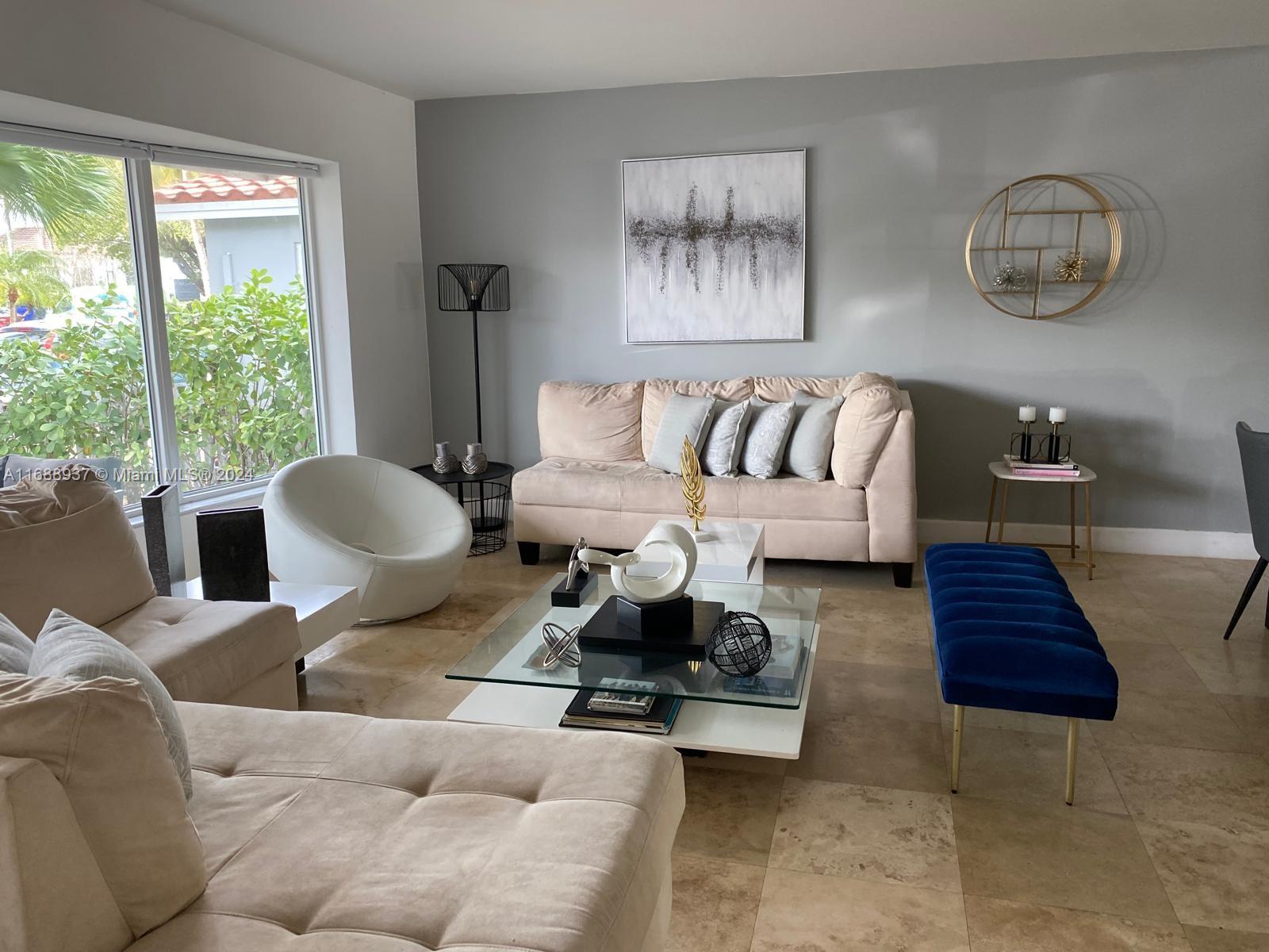 a living room with furniture lamp and window