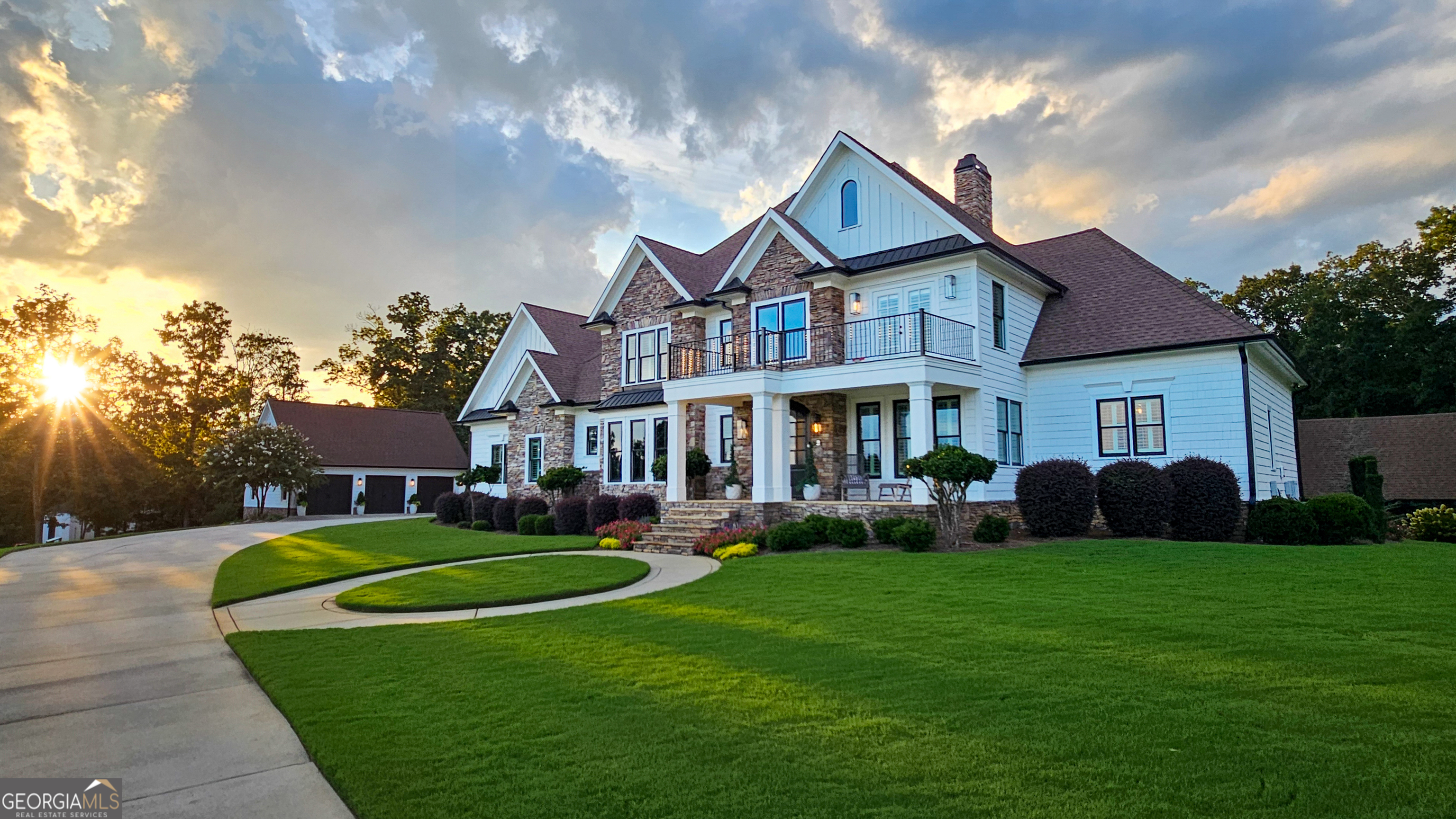 a front view of a house with a garden and trees