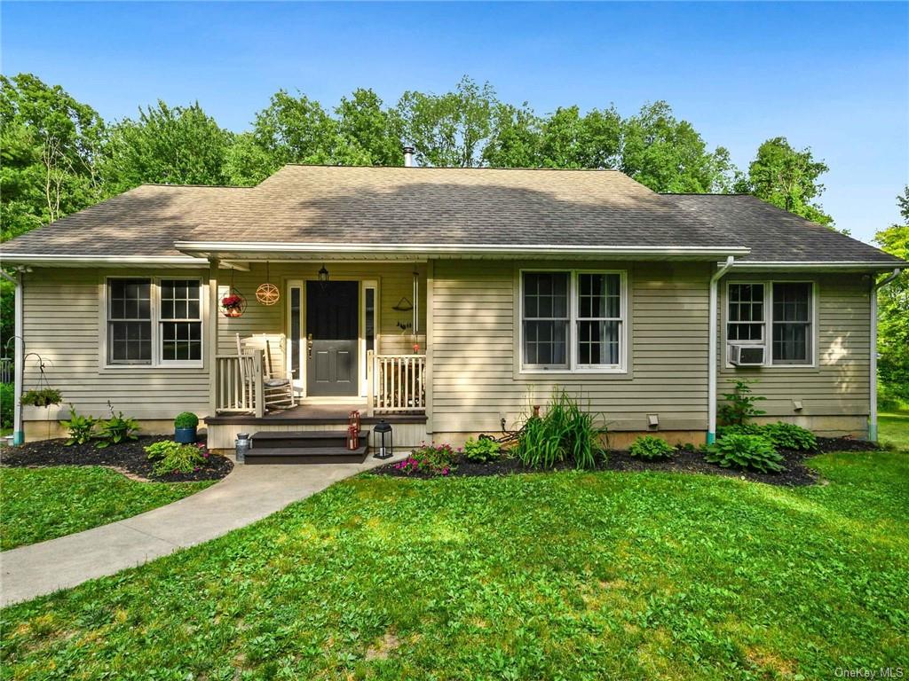 Ranch-style home featuring a front yard and covered porch