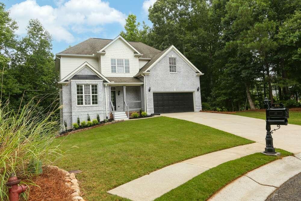 a front view of a house with yard