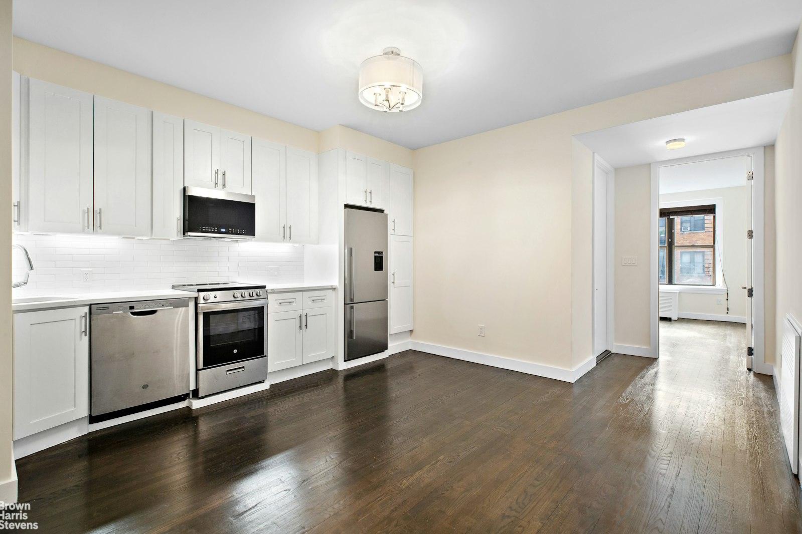 a kitchen with a stove a sink and a refrigerator