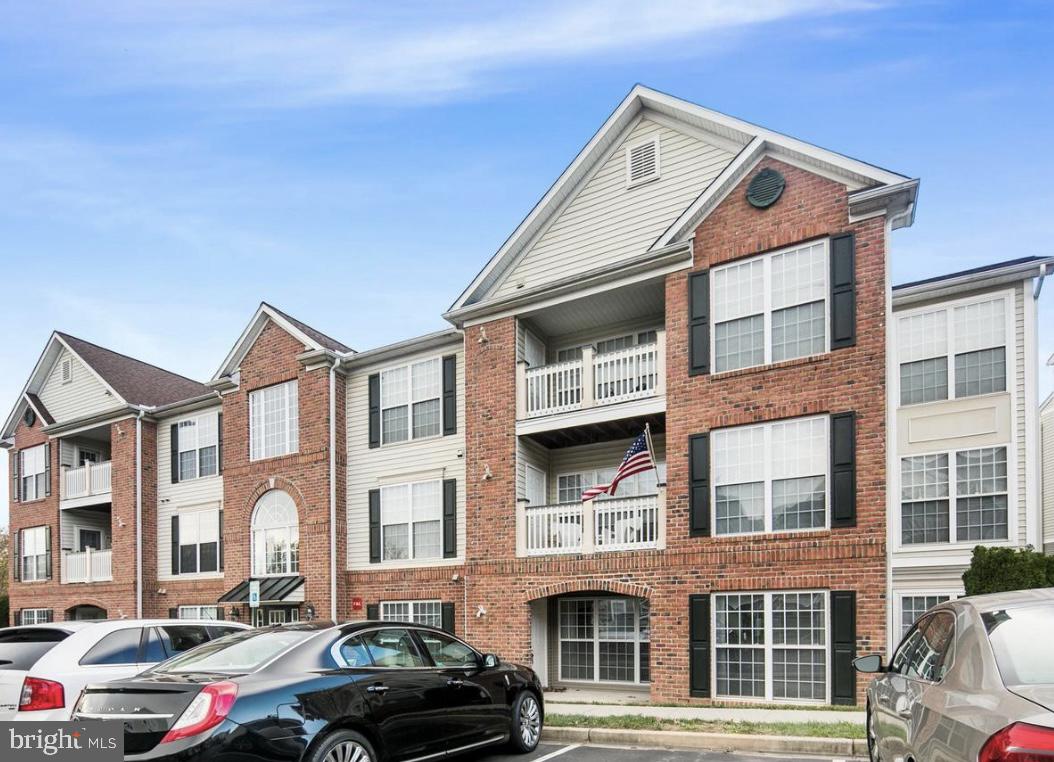 a front view of a residential apartment building with a yard