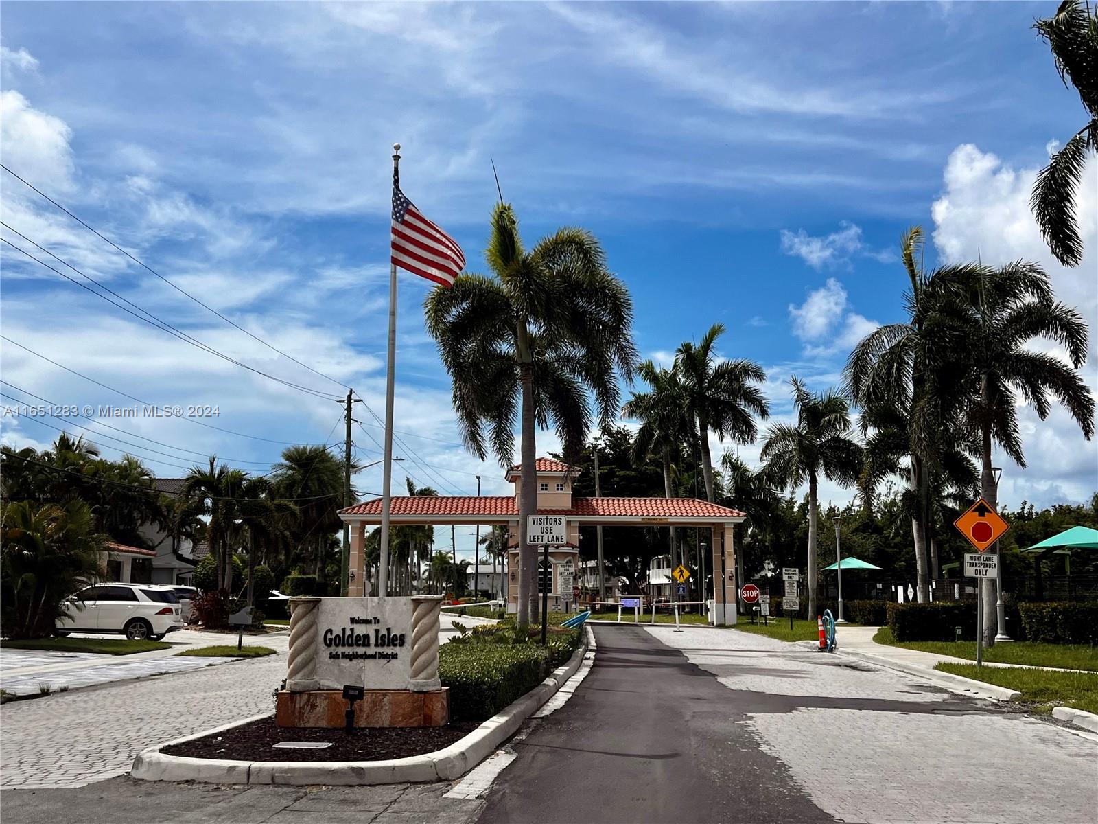 a front view of a building with palm trees