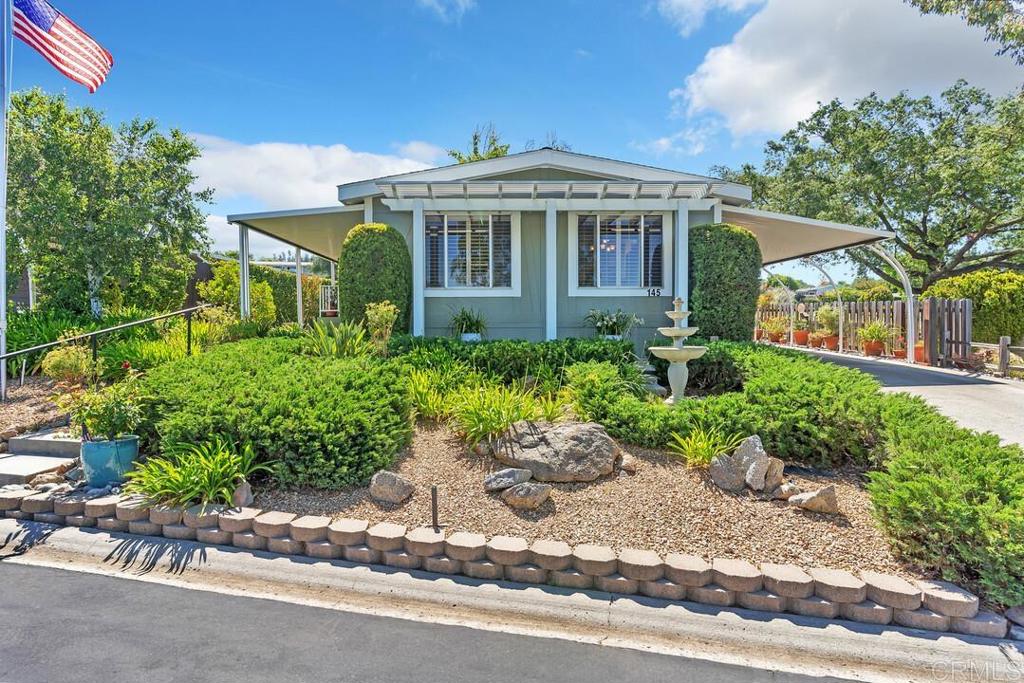 a front view of a house with a garden