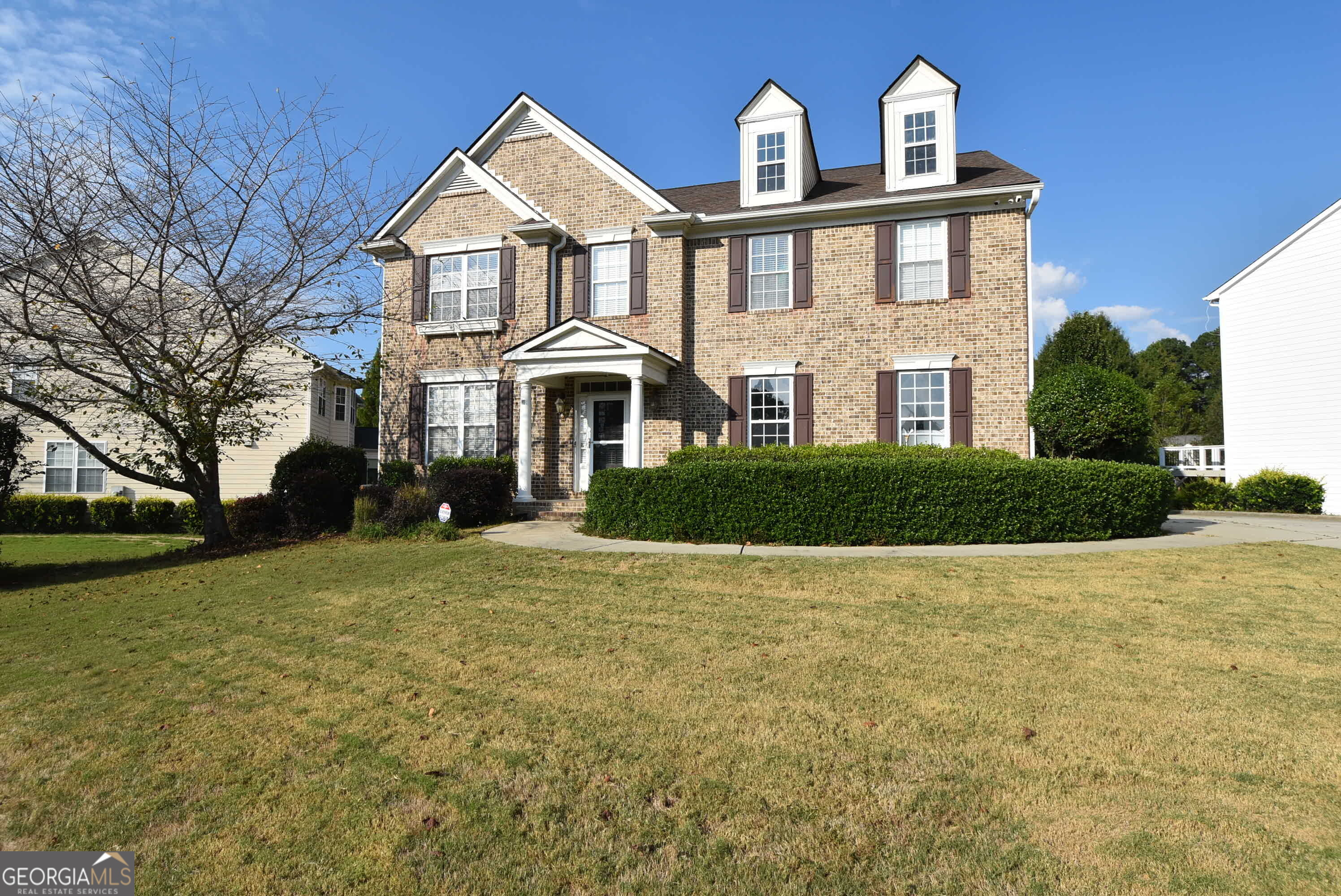 a front view of a house with garden