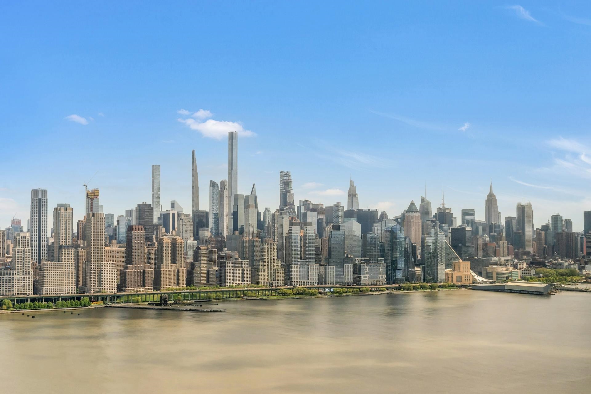 a view of a city with water and tall building in the background