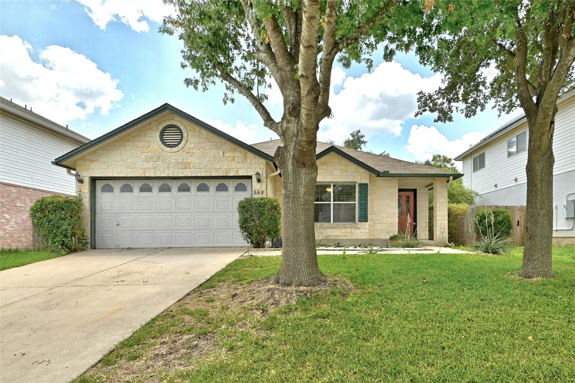 a front view of a house with a yard and garage